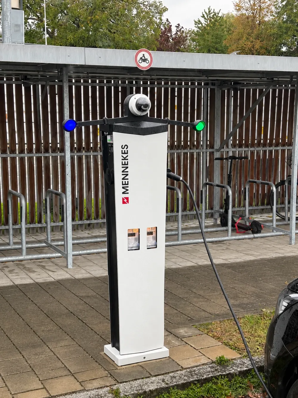 Charging station at Stadtwerk am See in Friedrichshafen with a camera and two round LEDs on top, blue on the left, green on the right